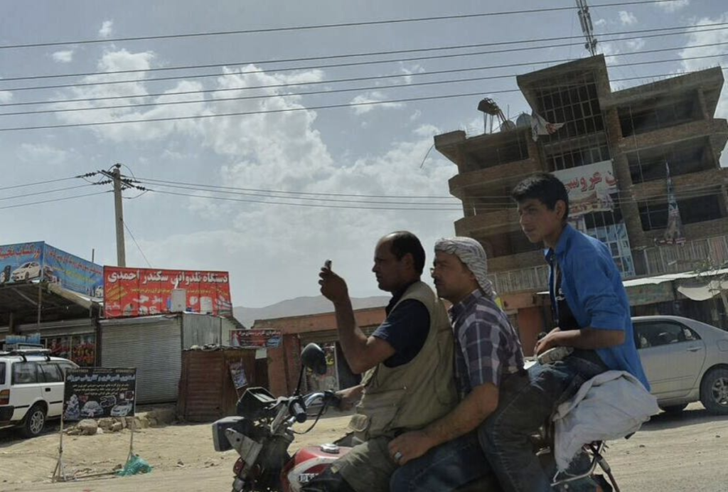 A photo of men sharing a motorbike ride near Kabul, Afghanistan in June 2016. (Chad Garland/Instagram)