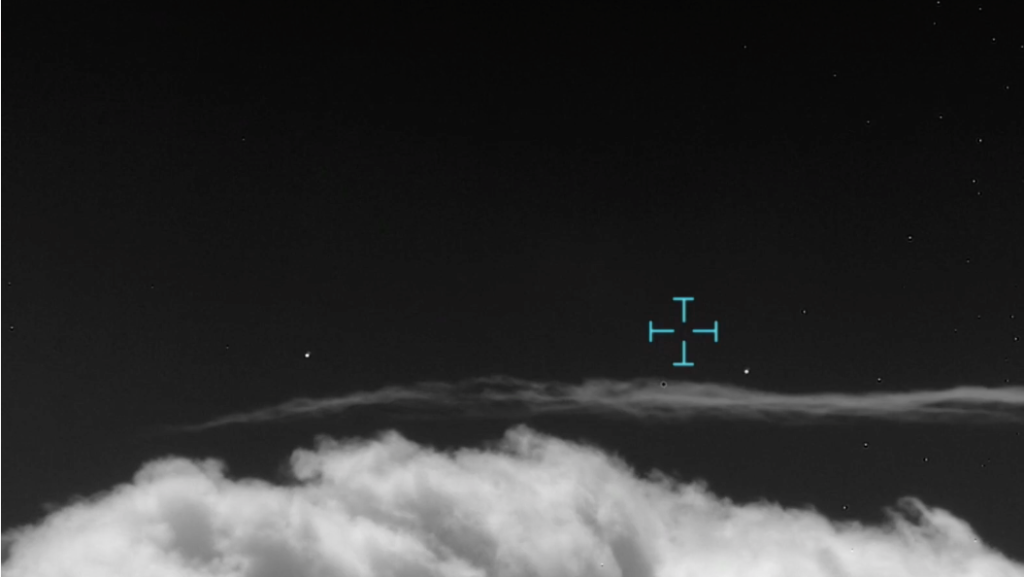 Two objects flying through clouds in a black and white infrared video screenshot
